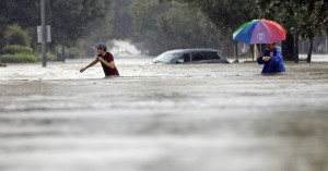 Moses Juarez, left, and Anselmo Padilla wade through floodwaters from Tropical Storm Harvey on Sunday, Aug. 27, 2017, in Houston, Texas. (AP Photo/David J. Phillip)